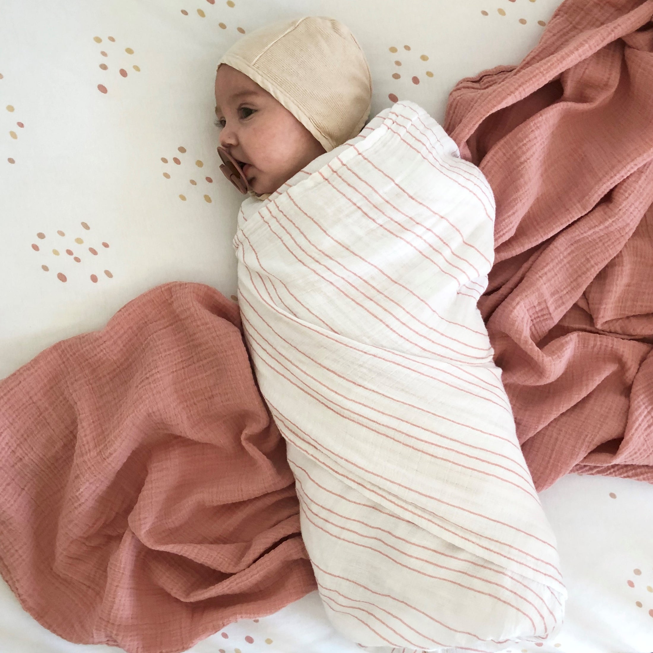 Newborn baby wrapped in a soft swaddle for hospital bag essentials